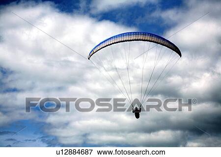A hang glider on a cloudy day View Large Photo Image Stock Photo - A hang glider on a cloudy day. Fotosearch