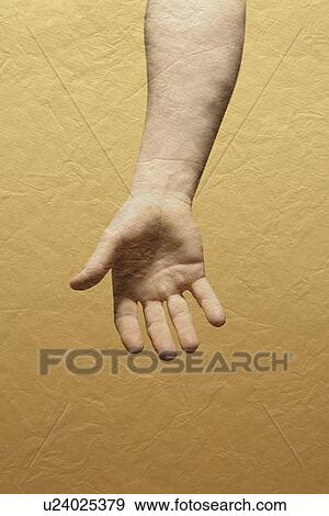 Stock Photo - A person's hand with yellow wall. Fotosearch