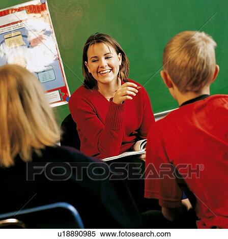 A teacher with students in a classroom View Large Photo Image Stock Photography - A teacher with students in a classroom. Fotosearch