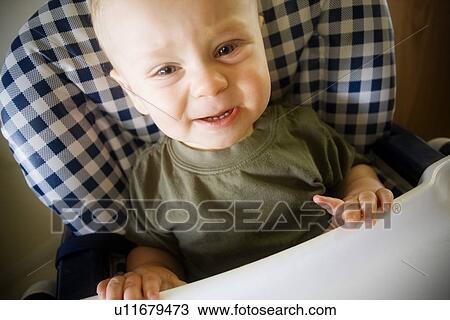 Baby boy crying in highchair View Large Photo Image Stock Image - Baby boy crying in highchair. Fotosearch