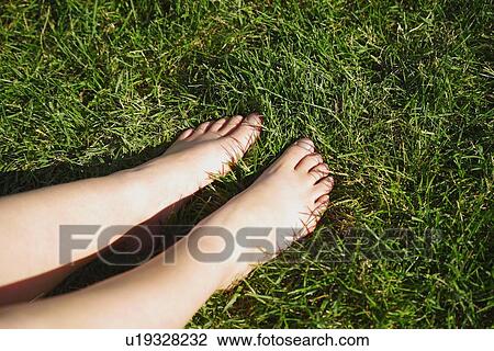 Bare feet on grass View Large Photo Image Stock Image - Bare feet on grass. Fotosearch