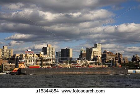 Barge passing Brooklyn Heights viewed from Lower Manhattan, New York City, New York, USA View Large Photo Image Picture - Barge passing Brooklyn Heights viewed from Lower Manhattan, New York City, New York, USA . Fotosearch