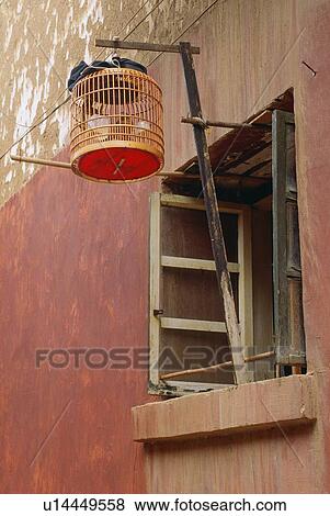 Stock Photo - Birdcage hanging from a window in Beijing, China. Fotosearch