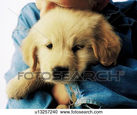 Stock Image - Boy hugging puppy. Fotosearch