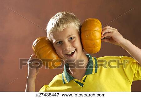 Stock Photo - Boy playing with pumpkins . Fotosearch