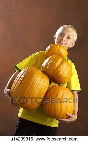 Boy playing with pumpkins View Large Photo Image Stock Photograph - Boy playing with pumpkins . Fotosearch