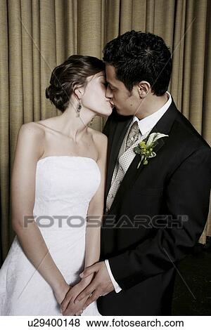 Stock Photo - Bride and groom kissing. Fotosearch