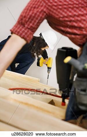 Carpenters working with electric tools View Large Photo Image Stock Image - Carpenters working with electric tools. Fotosearch