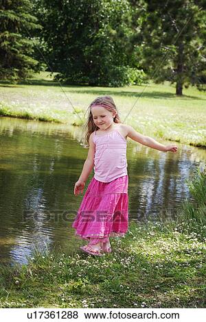 Child by the water View Large Photo Image Stock Photo - Child by the water. Fotosearch