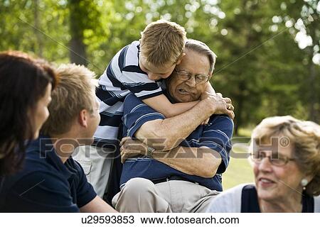 Stock Image - Child hugs grandfather. Fotosearch