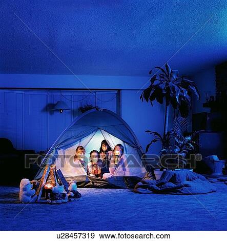 Children holding torches in a tent View Large Photo Image Stock Photo - Children holding torches in a tent. Fotosearch