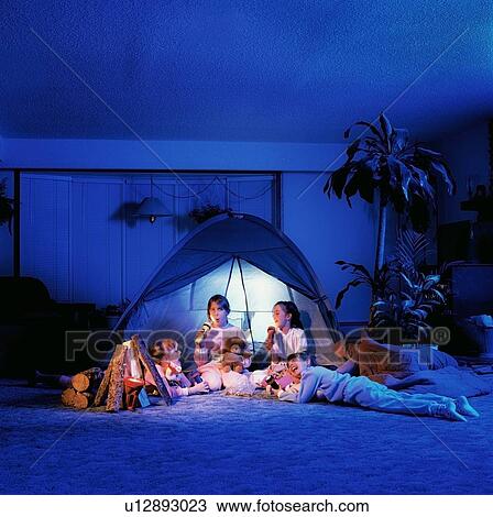 Stock Image - Children playing under a tent in the living room. Fotosearch