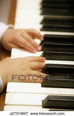 Child's hands playing piano View Large Photo Image Stock Photo - Child's hands playing piano . Fotosearch