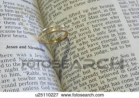 Closeup of a wedding ring with bible View Large Photo Image Stock Photo - Closeup of a wedding ring with bible. Fotosearch
