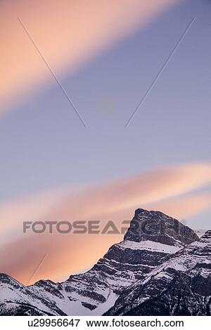 Stock Photo - Clouds at sunset above mountain peaks, Kootenay Plains, Alberta, Canada . Fotosearch