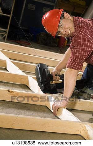 Content carpenter working with power tool View Large Photo Image Stock Photography - Content carpenter working with power tool. Fotosearch