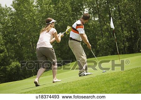 Couple golfing together View Large Photo Image Stock Image - Couple golfing together. Fotosearch
