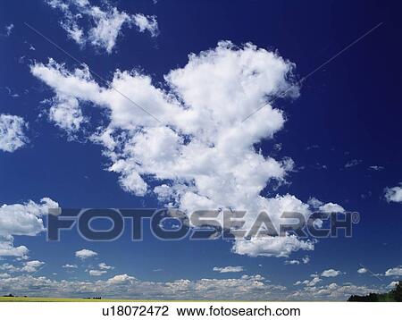 Stock Image - Cumulus clouds in Alberta, Canada. Fotosearch