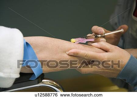 Stock Photograph - Doctor giving patient a needle . Fotosearch