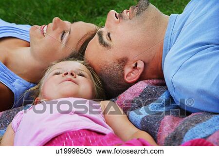 Family laying together View Large Photo Image Stock Photography - Family laying together. Fotosearch