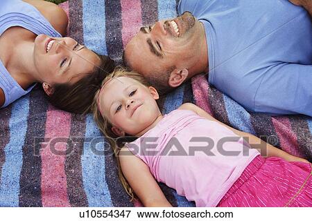 Stock Photo - Family lying down. Fotosearch