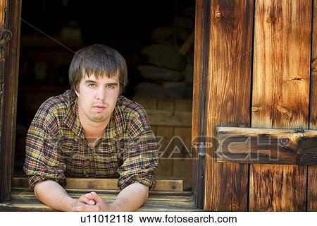 Front view of a man leaning in window View Large Photo Image Stock Photo - Front view of a man leaning in window. Fotosearch