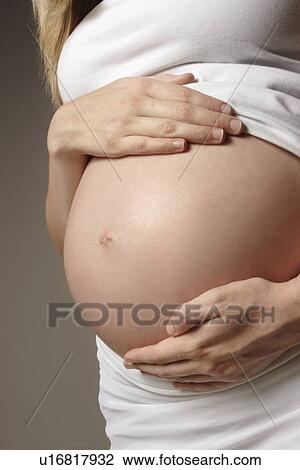 Stock Image - Front view of a pregnant woman. Fotosearch