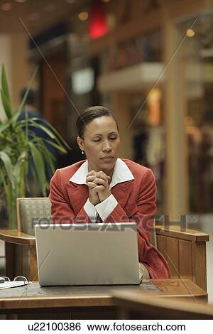 Stock Photograph - Front view of a woman praying. Fotosearch