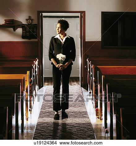 Front view of a woman standing in church View Large Photo Image Picture - Front view of a woman standing in church. Fotosearch