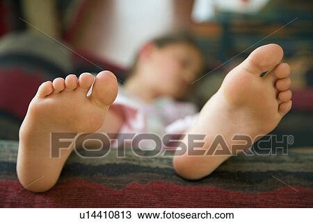 Girl lying on sofa View Large Photo Image Stock Image - Girl lying on sofa. Fotosearch
