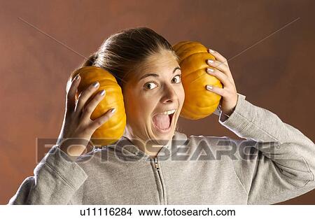 Girl playing with pumpkins View Large Photo Image Picture - Girl playing with pumpkins . Fotosearch