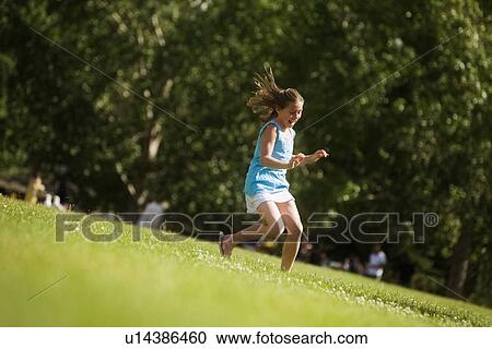 Girl running in the park View Large Photo Image Stock Image - Girl running in the park. Fotosearch