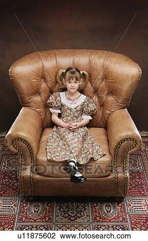 Girl sitting in large armchair View Large Photo Image Stock Image - Girl sitting in large armchair. Fotosearch