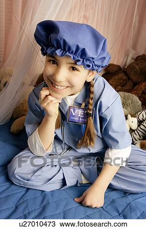Girl smiling on bed View Large Photo Image Stock Image - Girl smiling on bed. Fotosearch