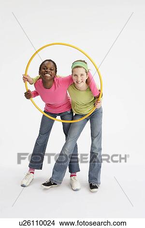 Girls holding yellow hula hoop View Large Photo Image Picture - Girls holding yellow hula hoop. Fotosearch