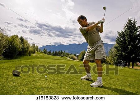 Stock Photo - Golfer taking his first shot. Fotosearch