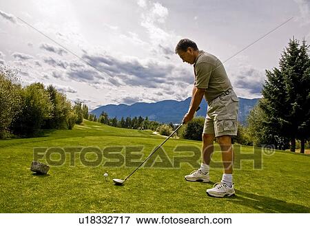 Stock Photo - Golfer taking his first shot. Fotosearch