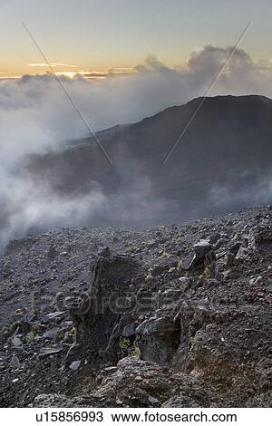 Stock Image - Haleakala crater with smoke. Fotosearch