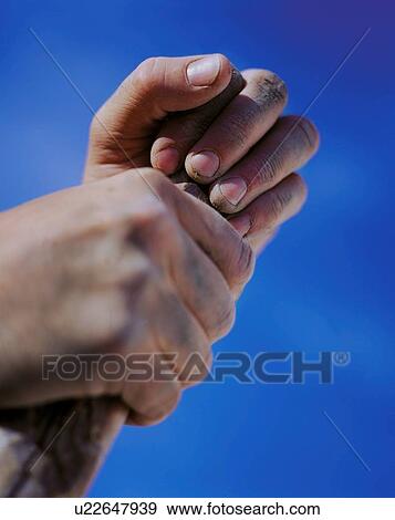 Stock Photo - Hands holding stick against blue sky. Fotosearch