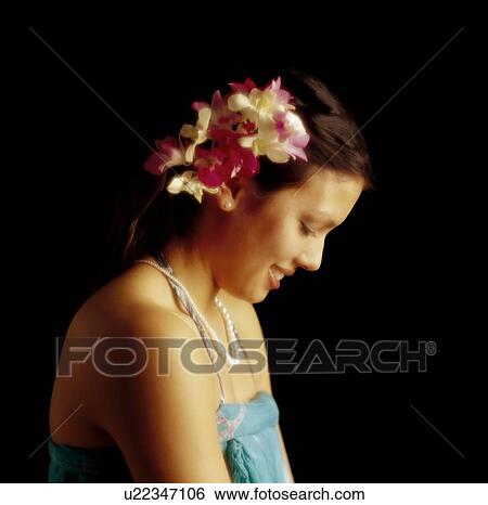 Hawaiian woman with flowers in her hair View Large Photo Image Stock Photograph - Hawaiian woman with flowers in her hair. Fotosearch