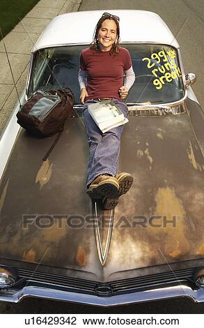 High angle view of a girl leaning over car bonnet View Large Photo Image Stock Image - High angle view of a girl leaning over car bonnet. Fotosearch