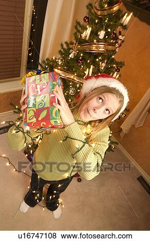 Holding a Christmas present View Large Photo Image Stock Photo - Holding a Christmas present. Fotosearch