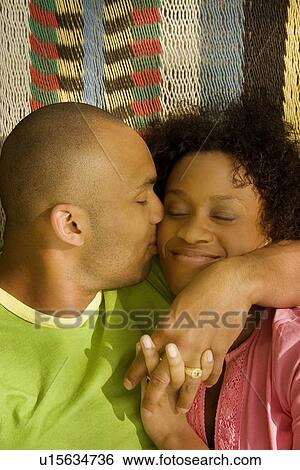 Stock Photograph - Husband kissing wife. Fotosearch