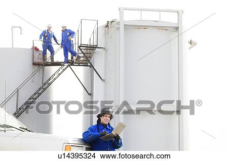 Industrial workers at an oilfield View Large Photo Image Picture - Industrial workers at an oilfield. Fotosearch