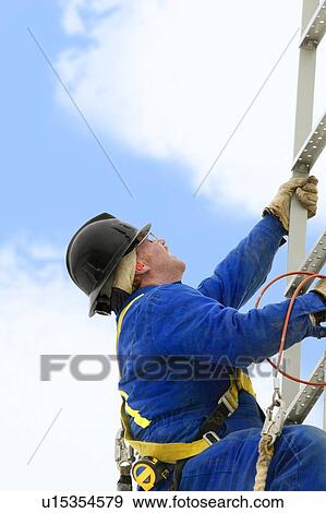 Industry worker climbing a ladder View Large Photo Image Stock Photo - Industry worker climbing a ladder. Fotosearch