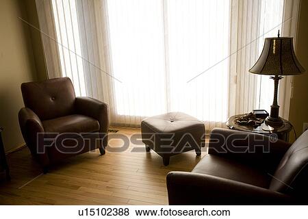 Stock Photo - Living room with armchairs and ottoman. Fotosearch