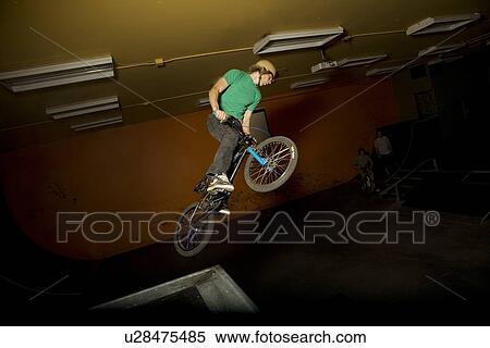 Man doing bicycle stunt View Large Photo Image Stock Photography - Man doing bicycle stunt. Fotosearch