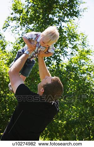 Man holding child View Large Photo Image Stock Image - Man holding child. Fotosearch