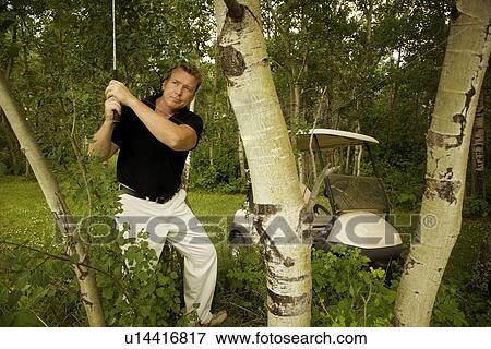 Stock Photo - Man playing golf. Fotosearch