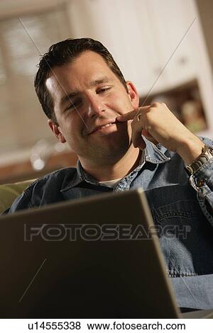 Man sitting with laptop computer View Large Photo Image Stock Photo - Man sitting with laptop computer. Fotosearch